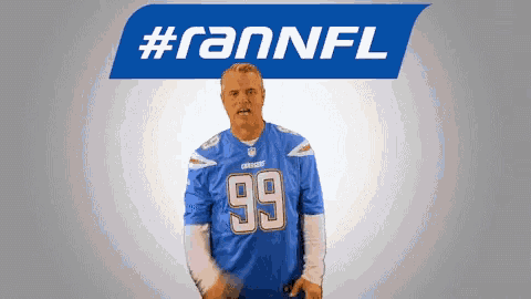 a man wearing a number 99 jersey stands in front of a #rannfl logo