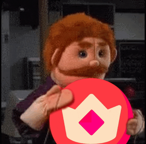 a puppet is holding a red circle with a crown in it
