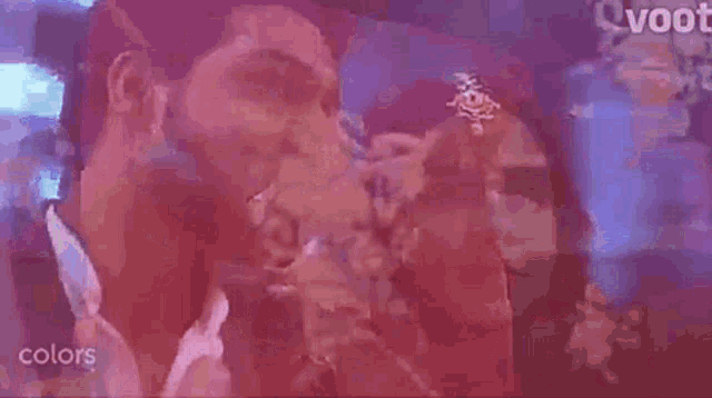 a man and a woman are standing next to each other in a dark room .