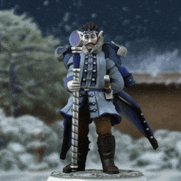 a statue of a man in a blue coat holding a cane in the snow