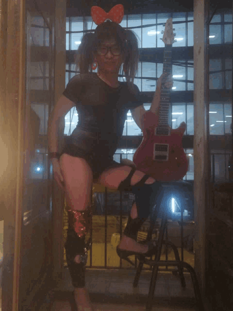 a woman with a bow on her head holds a guitar