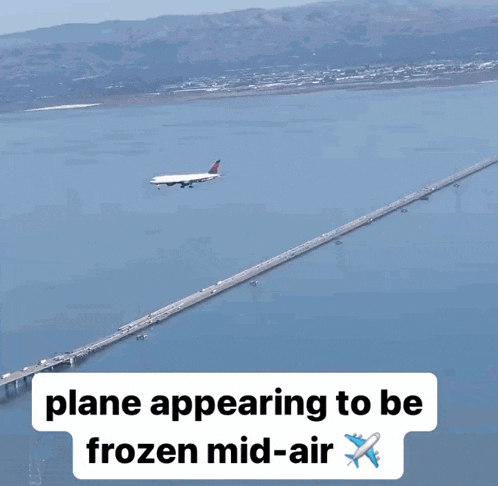 a plane is flying over a bridge with the words plane appearing to be frozen mid-air