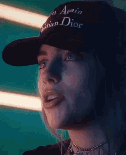 a close up of a woman wearing a hat that says christian dior .