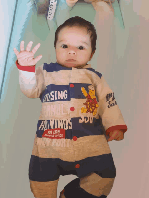 a baby wearing a striped outfit that says cruising on the front