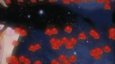 a woman in a dress is surrounded by red flowers in the sky .
