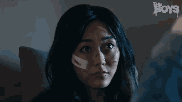 a woman with a bandage on her face and the words the boys on the wall