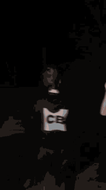 a blurry picture of a person wearing a hoodie with the word cb on it .