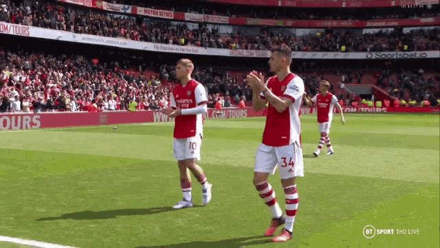 a soccer player wearing number 34 applauds the crowd