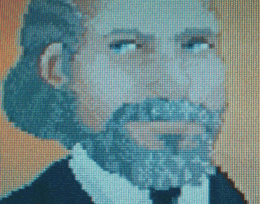 a portrait of a man with a beard is displayed on a computer screen