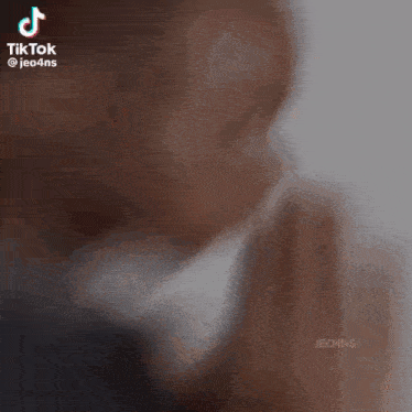 a man is praying with his hands together in a blurry photo .