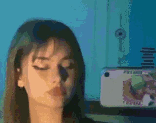 a close up of a woman taking a selfie with her phone .