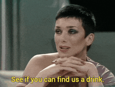 a woman says " see if you can find us a drink " in yellow letters