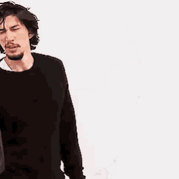 a man with a beard is wearing a black sweater .