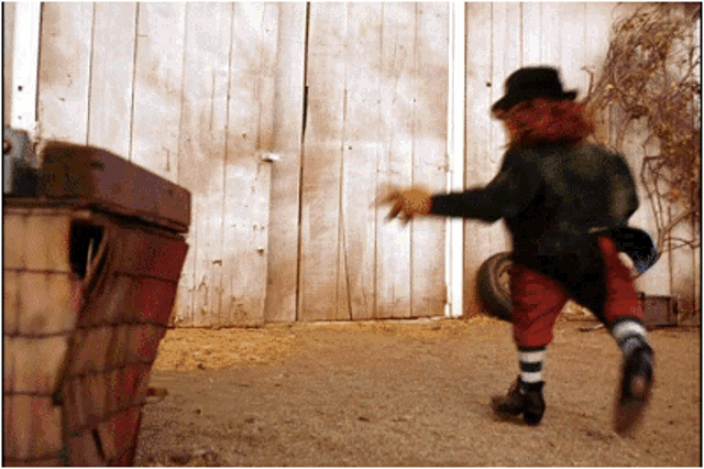 a leprechaun standing in front of a white barn