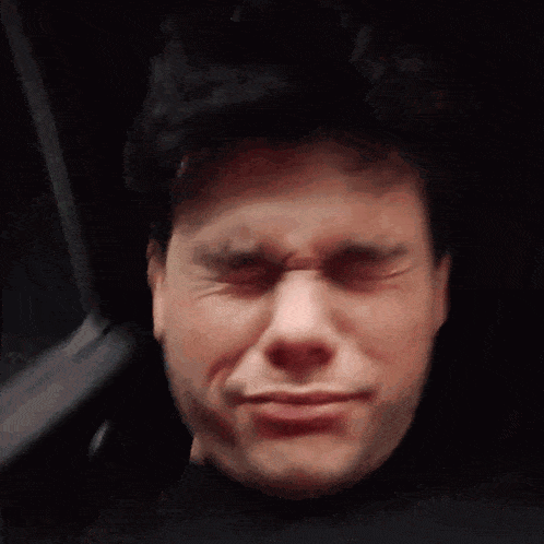 a close up of a man 's face with tears coming out of his eyes
