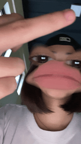 a blurry picture of a person 's face with a hat that says ' mlb ' on it