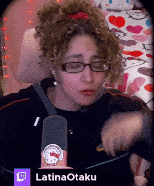 a woman wearing glasses and a hello kitty sticker on her hand