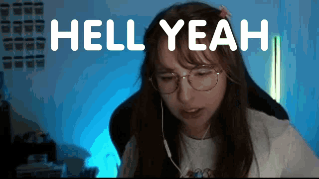 a woman wearing glasses says hell yeah