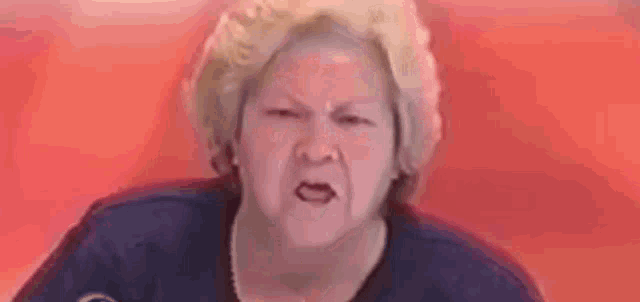 a woman in a scrub top is making a funny face .