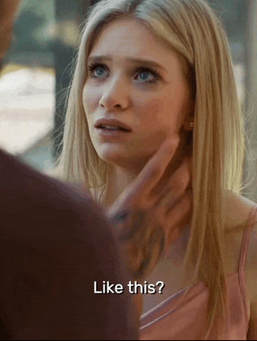 a woman in a pink dress is being touched by a man in a brown shirt and says " like this "