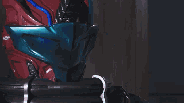 a close up of a robot 's head with a blue helmet on