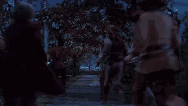 a group of men in pirate costumes are dancing in a park .
