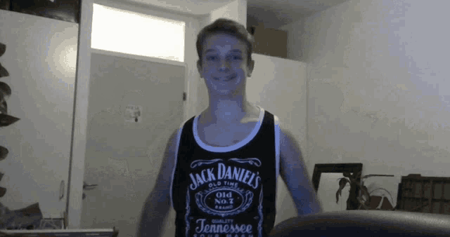 a young man wearing a jack daniel 's old time tennessee tank top