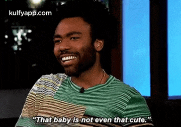a man is smiling and talking about a baby .