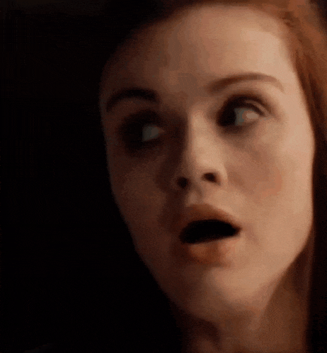 a close up of a woman 's face with her mouth open and her eyes closed .