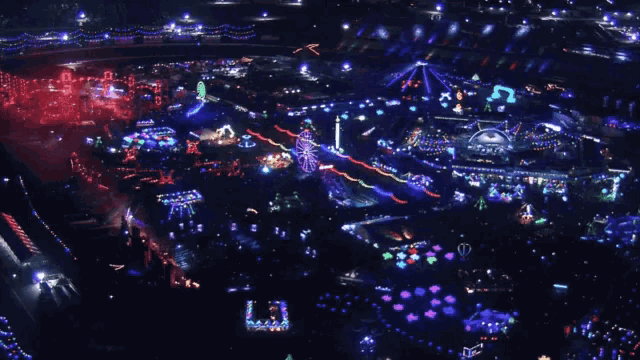 an aerial view of a carnival filled with lots of lights