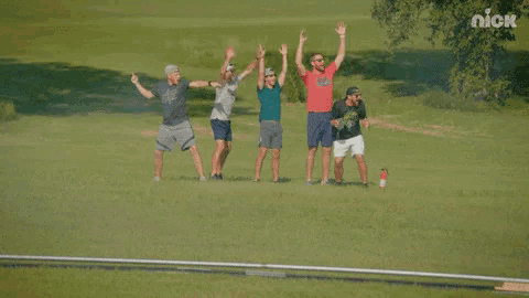 a group of men standing in a field with a nick logo in the corner