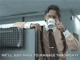 a man in a suit and tie is drinking a cup of coffee while leaning against a wall .