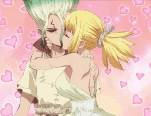 a man and a woman are kissing in front of pink hearts