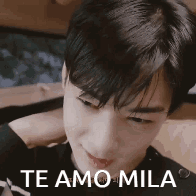 a close up of a person 's face with the words te amo mila written above it