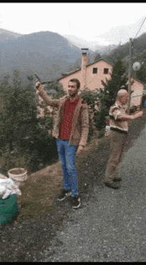 a man in a brown jacket is holding a gun in his right hand