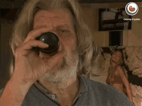 a man with a beard says lekker in front of a picture of a woman