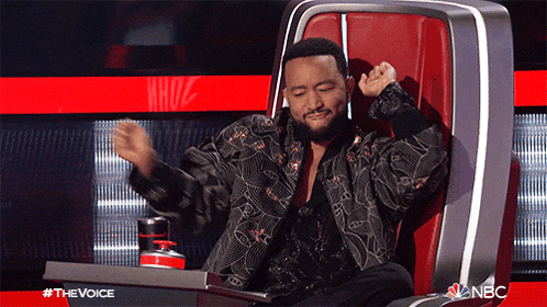 a man with a beard is sitting in a chair with his arms outstretched and the words the voice behind him