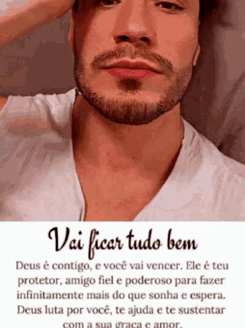 a man with a beard is wearing a white shirt with a quote in portuguese .