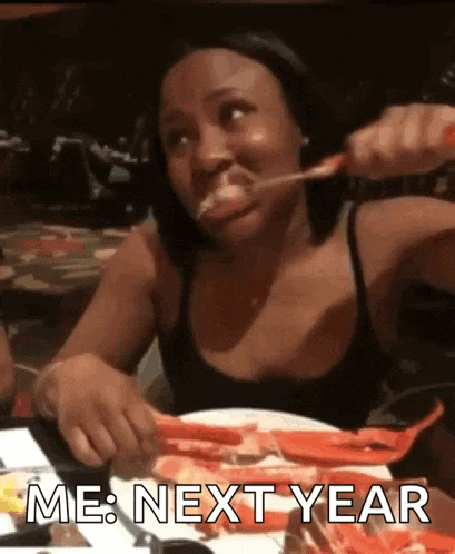 a woman is sitting at a table with a plate of food and the words me next year written on it