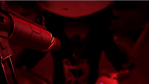 a close up of a person 's eyes with purple lights coming out of them in the dark .