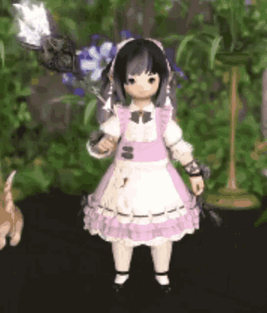 a little girl in a pink and white dress is standing in front of a plant .