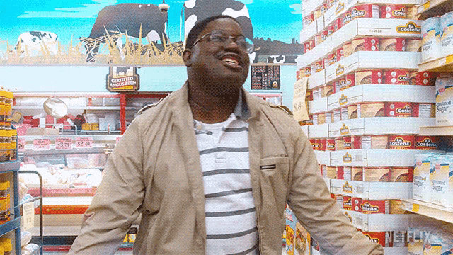 a man is shopping in a grocery store with a sign that says " chicken beef "