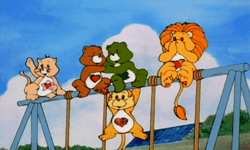 a group of care bears and a lion on a swing set