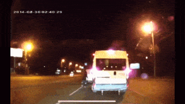 a white van is driving down a street at night with the date 2014-08-30 at the bottom