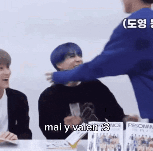 a man with blue hair is hugging another man with blue hair .