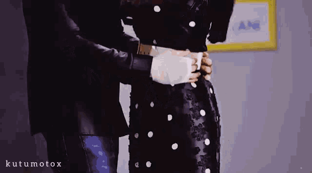 a man is holding a woman 's waist with a bandage on her arm .