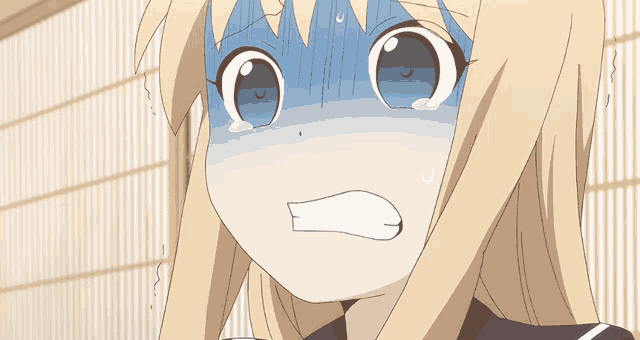 a close up of a girl 's face with a surprised expression