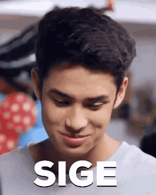 a young man is smiling and the word sige is on the bottom