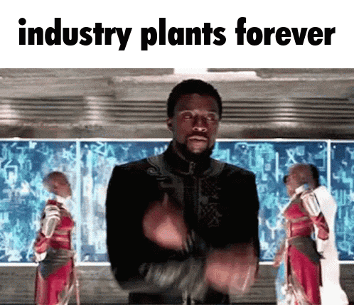 a man is standing in front of a screen that says industry plants forever .