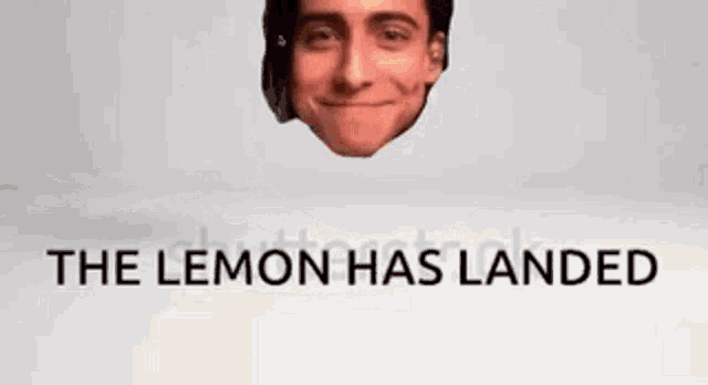 a man 's face is sticking out of a hole in a lemon with the words `` the lemon has landed '' .